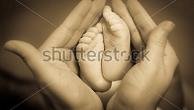 stock-photo-baby-feet-in-mother-s-hands-155999342.jpg
